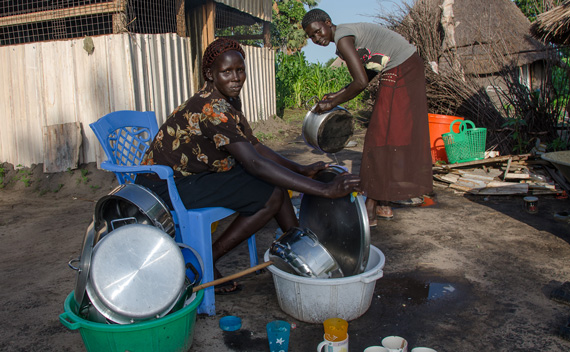 Tabitha and Rebecca, ASAH cooks, scrub the dishes outside our temporary kitchen.
